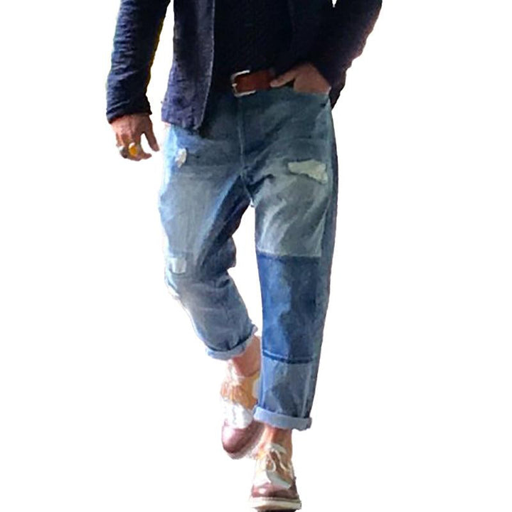 Męskie jeansy vintage z przetarciami i łatami 00359354Y